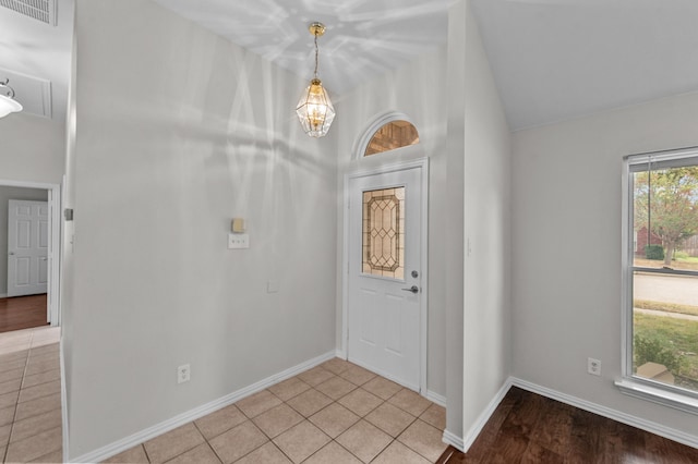 foyer entrance featuring lofted ceiling and light tile patterned floors