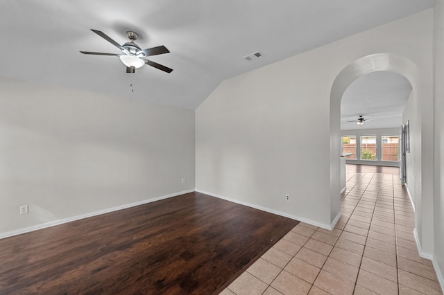 unfurnished room with vaulted ceiling, light hardwood / wood-style flooring, and ceiling fan