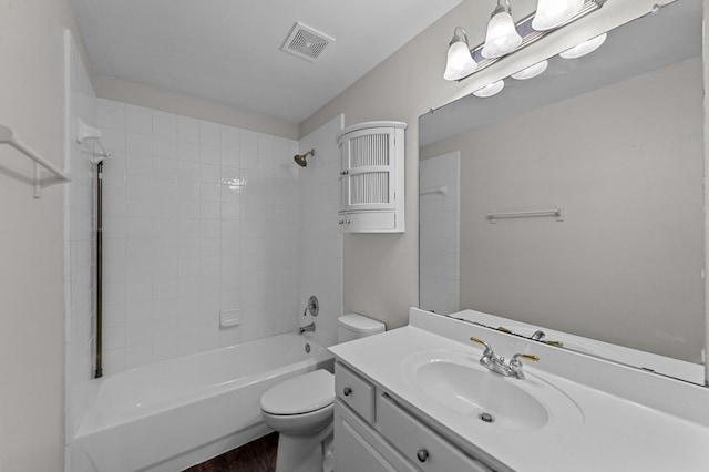 full bathroom with vanity, tiled shower / bath combo, wood-type flooring, and toilet