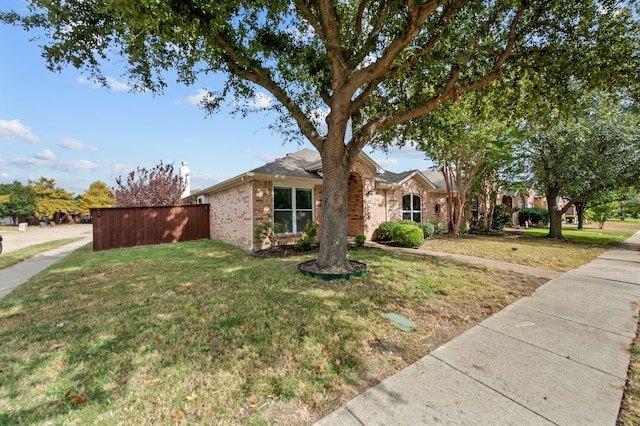 ranch-style home with a front lawn