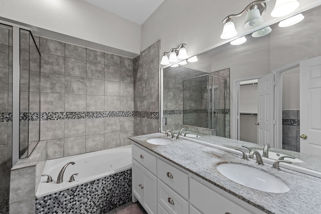 bathroom with vanity and independent shower and bath