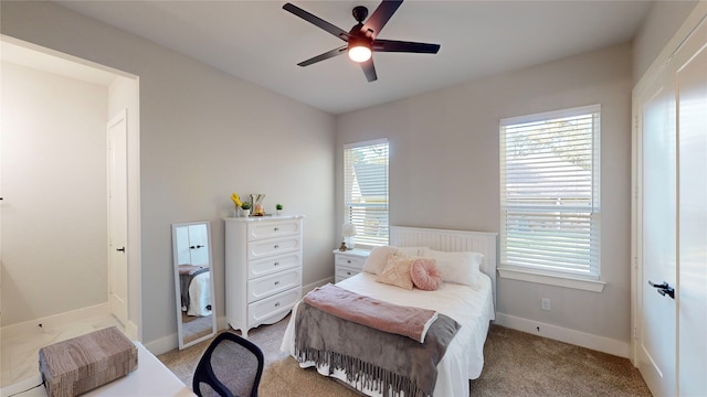 bedroom with ceiling fan and light carpet