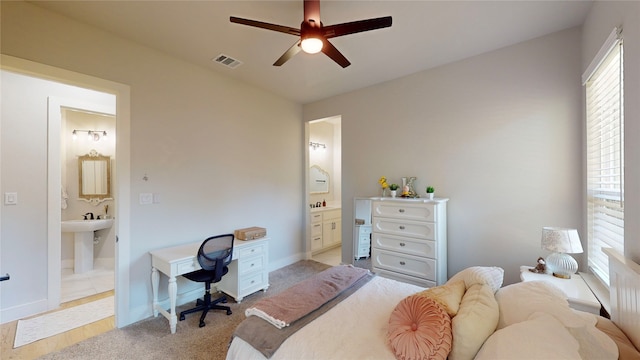 carpeted bedroom with ceiling fan and ensuite bathroom