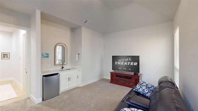 living room featuring light colored carpet and sink