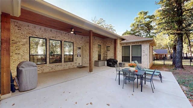 view of patio with area for grilling and ceiling fan