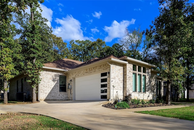 view of front of home with a garage and central AC unit