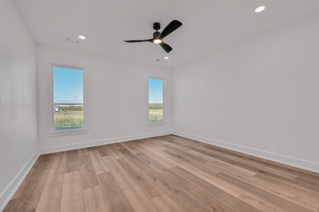 empty room featuring light wood-type flooring and ceiling fan