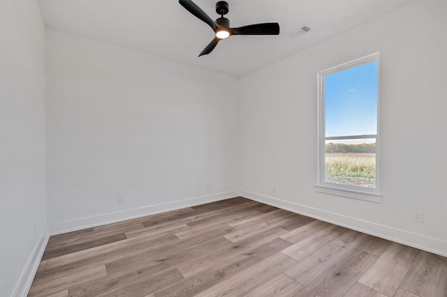 spare room featuring ceiling fan and light hardwood / wood-style flooring