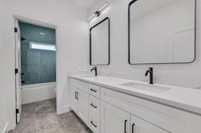 full bathroom featuring vanity, toilet, and tiled shower / bath