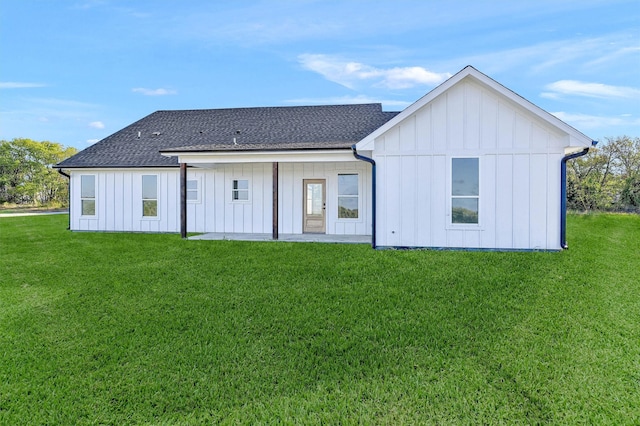 rear view of property featuring a yard