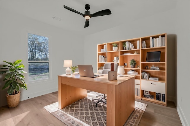 office with ceiling fan and light hardwood / wood-style floors