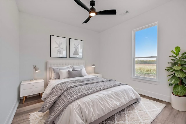 bedroom with ceiling fan and light wood-type flooring