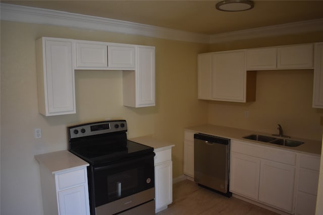 kitchen with sink, appliances with stainless steel finishes, crown molding, and white cabinets