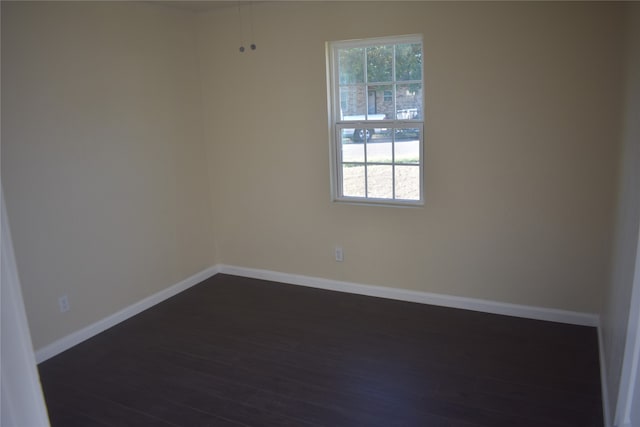 spare room with dark wood-type flooring