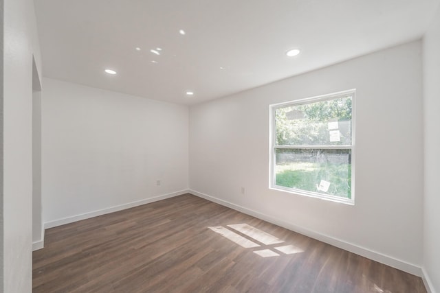 spare room with dark hardwood / wood-style flooring