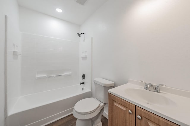 full bathroom with toilet, hardwood / wood-style floors, vanity, and  shower combination