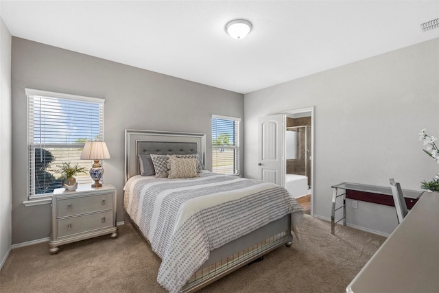 bedroom featuring carpet flooring, baseboards, and connected bathroom