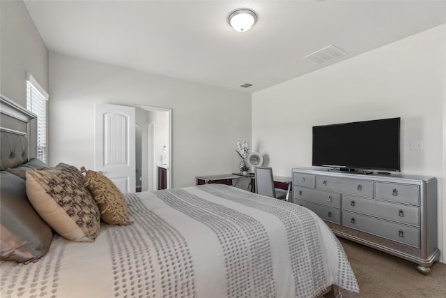 carpeted bedroom featuring visible vents
