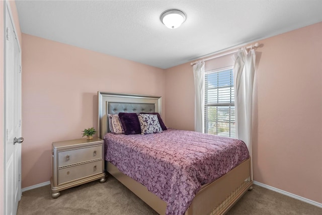 carpeted bedroom with baseboards