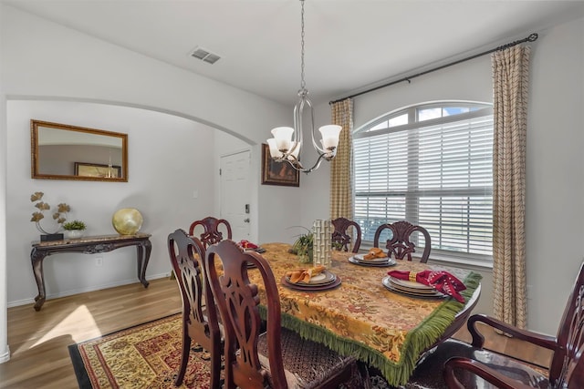 dining room with a notable chandelier and hardwood / wood-style flooring