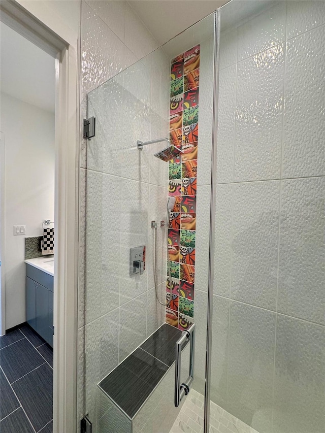 bathroom with an enclosed shower, vanity, and tile patterned floors