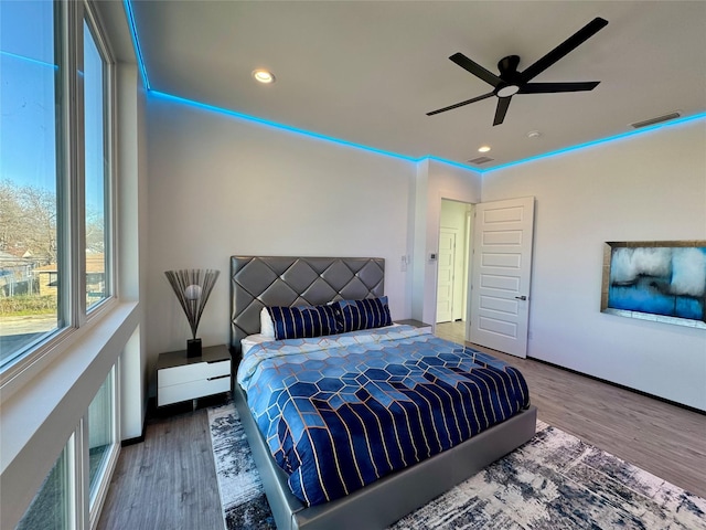 bedroom with ceiling fan and hardwood / wood-style flooring