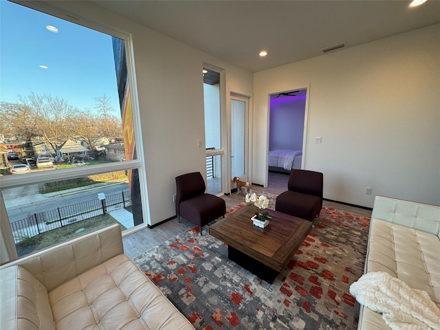 living room with a healthy amount of sunlight and hardwood / wood-style floors