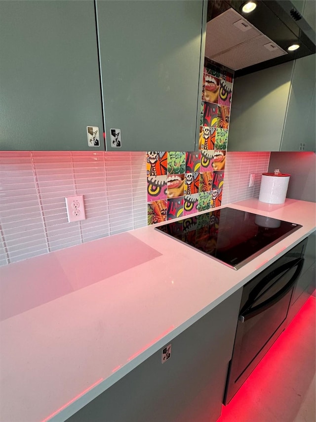 kitchen with tasteful backsplash, black electric stovetop, green cabinetry, exhaust hood, and oven