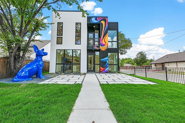 rear view of property with a lawn