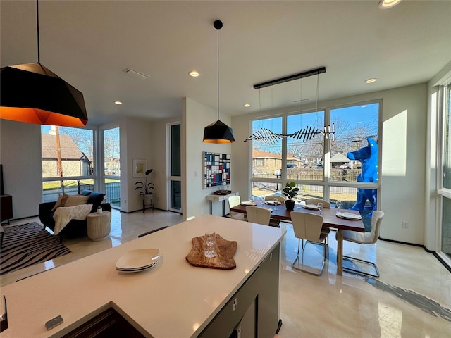 kitchen with decorative light fixtures and a wealth of natural light