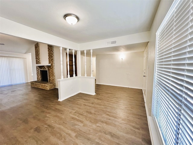 unfurnished living room with a brick fireplace