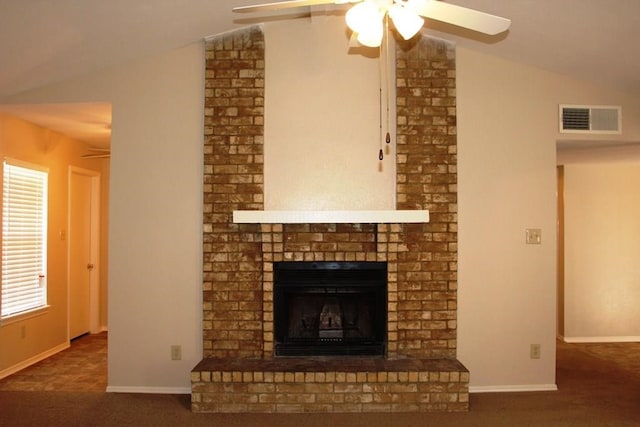 unfurnished living room featuring ceiling fan, vaulted ceiling, and a fireplace