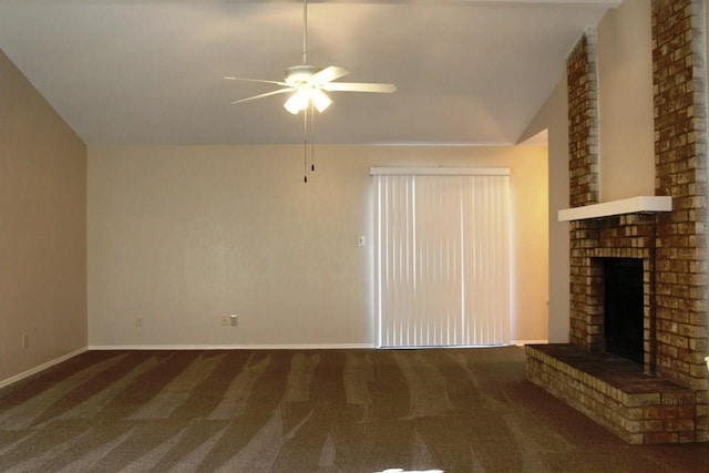 unfurnished living room with ceiling fan, a fireplace, lofted ceiling, and dark colored carpet