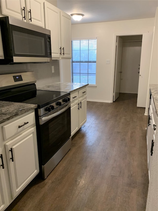 kitchen with dark wood-type flooring, appliances with stainless steel finishes, decorative backsplash, and white cabinetry