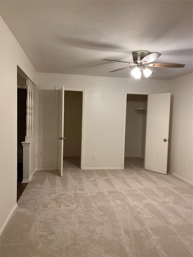 unfurnished bedroom with light colored carpet and ceiling fan