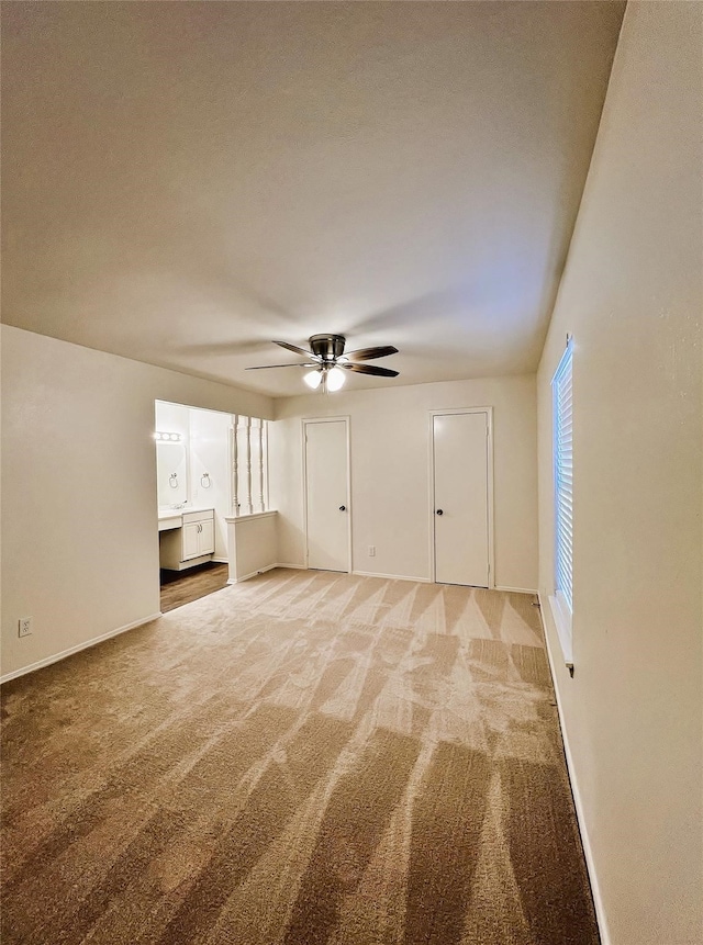 unfurnished room with carpet floors and ceiling fan