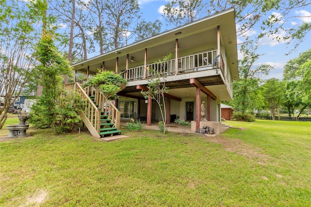 back of property featuring a deck and a yard