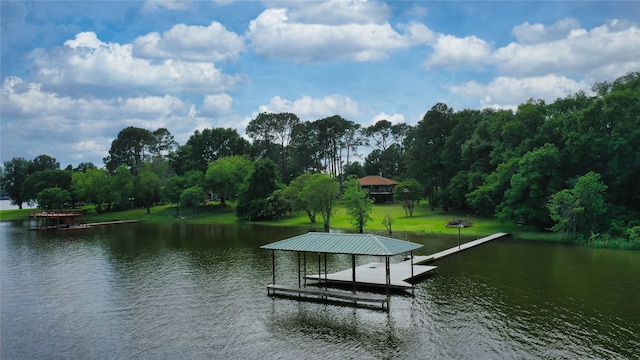 view of dock with a water view and a lawn