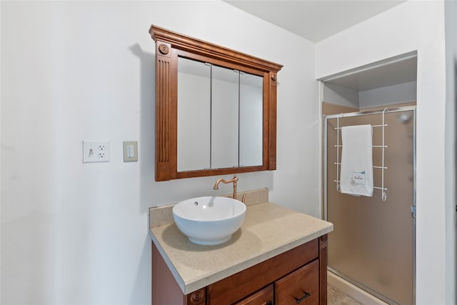 bathroom featuring vanity and an enclosed shower