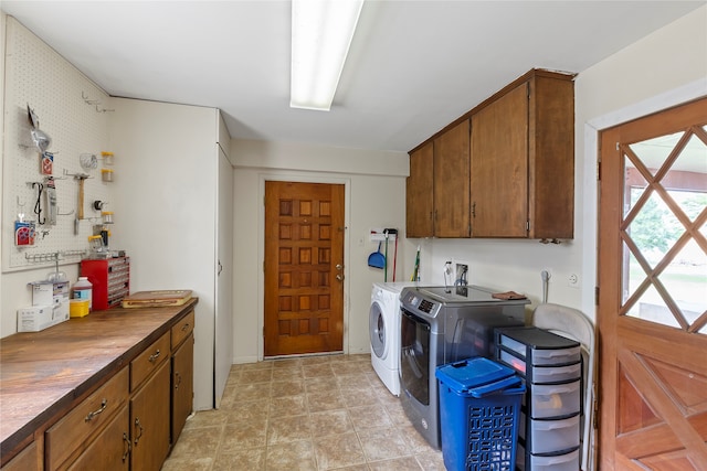 laundry room featuring independent washer and dryer and cabinets