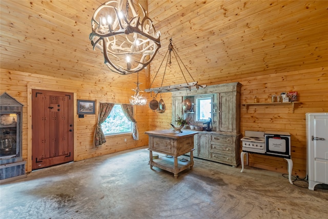 office area featuring a high ceiling, concrete flooring, an inviting chandelier, and wood walls