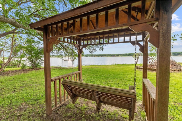 exterior space with a water view and a lawn