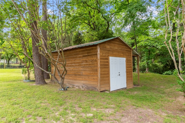 view of outdoor structure featuring a lawn