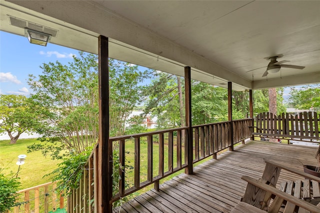 deck featuring a yard and ceiling fan