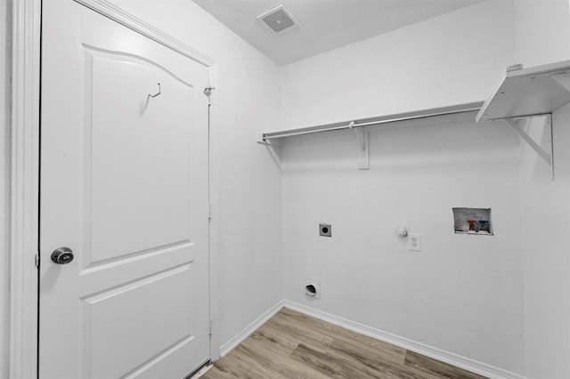 washroom with light wood-type flooring, gas dryer hookup, hookup for a washing machine, and hookup for an electric dryer