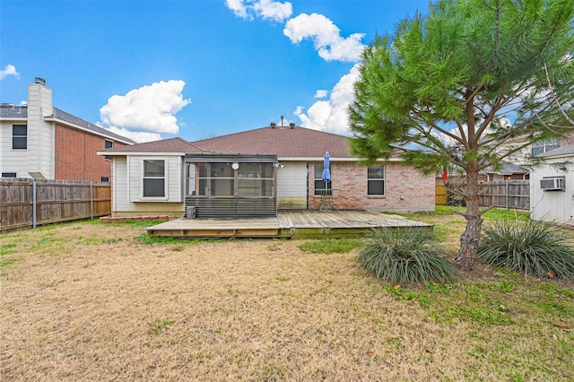 back of property featuring a yard and a wooden deck