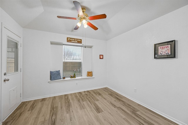 spare room featuring vaulted ceiling, ceiling fan, and light hardwood / wood-style flooring