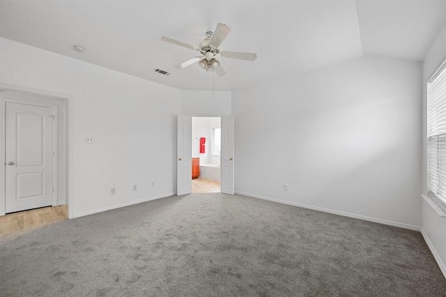 carpeted empty room featuring ceiling fan and vaulted ceiling