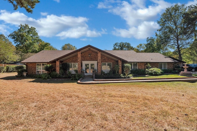 ranch-style home featuring french doors and a front yard