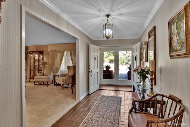 foyer with french doors, a chandelier, a textured ceiling, and dark colored carpet